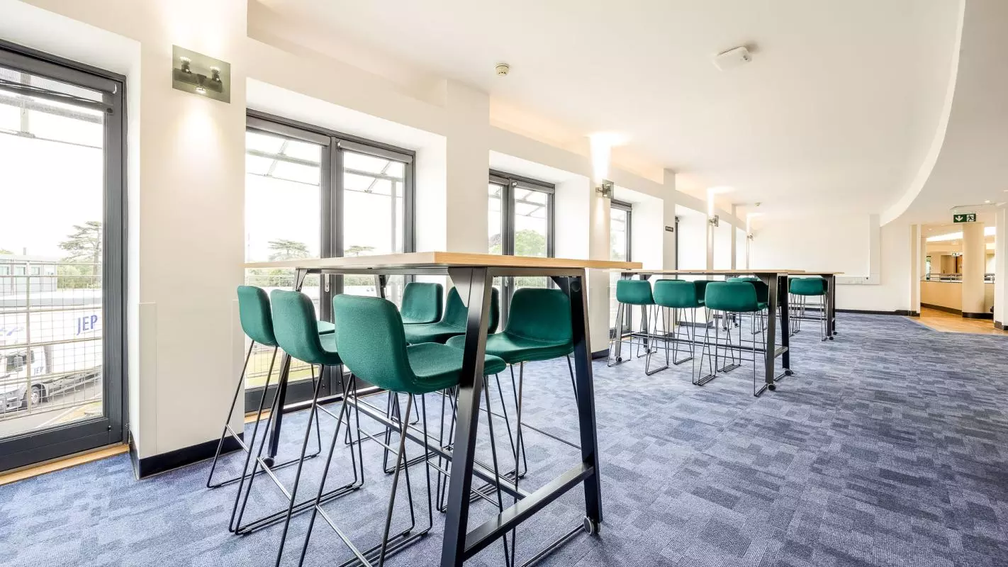 Curved room with high tables and chairs