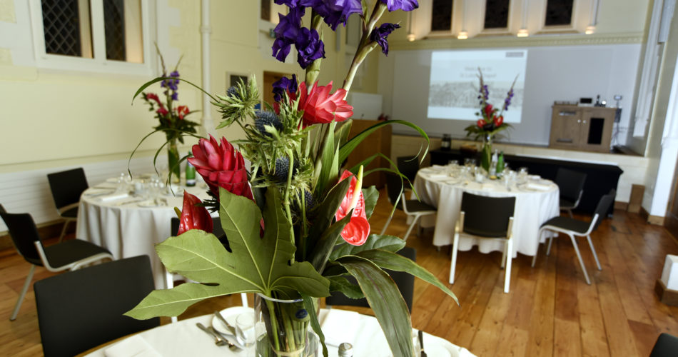 A beautiful floral display on the dining tables at St Luke's chapel