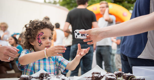 This is an image of a child reaching out for an ice-cream at a party held at Osler House