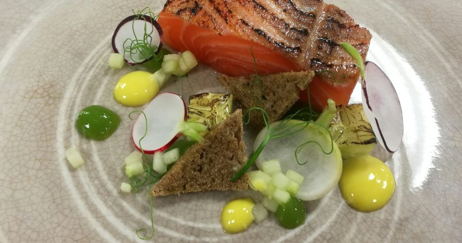 A picture of a salmon dish, an illustrative example of the quality of food we provide