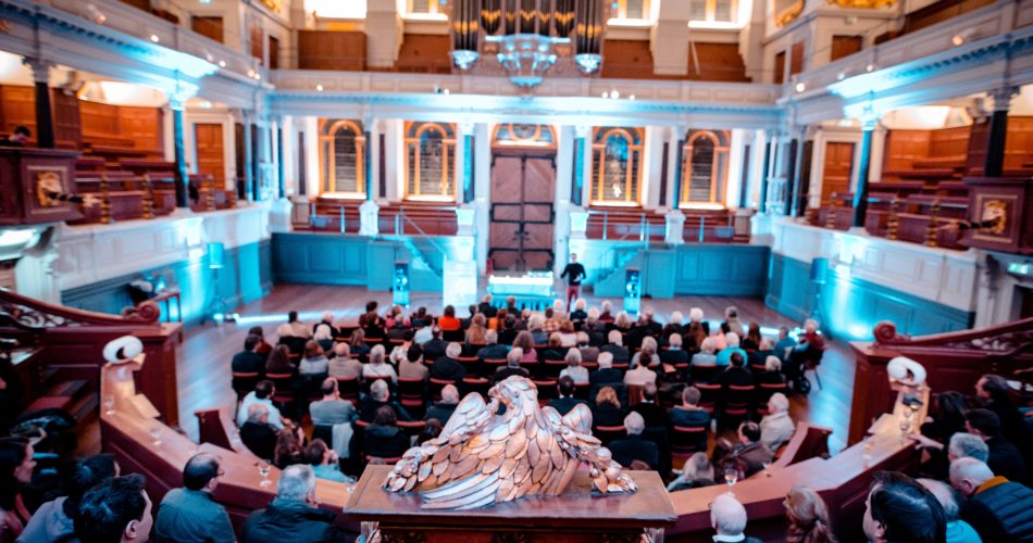 Audience listening in Sheldonian Theatre lecture venue Oxford